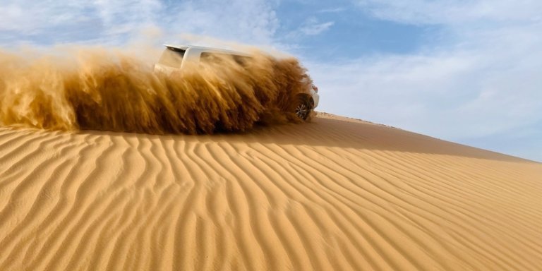 Abu Dhabi Morning Desert Safari with Camel Ride & Sandboarding